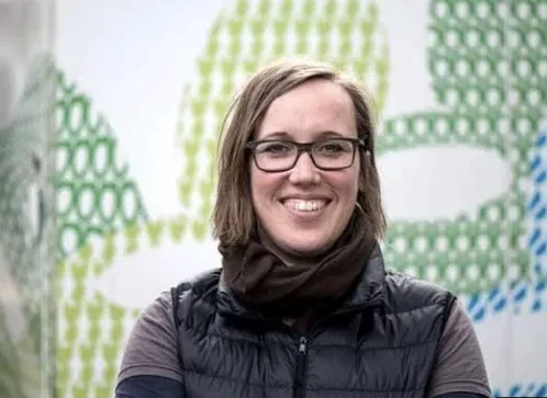 Loowatt team member in front of the company's branding